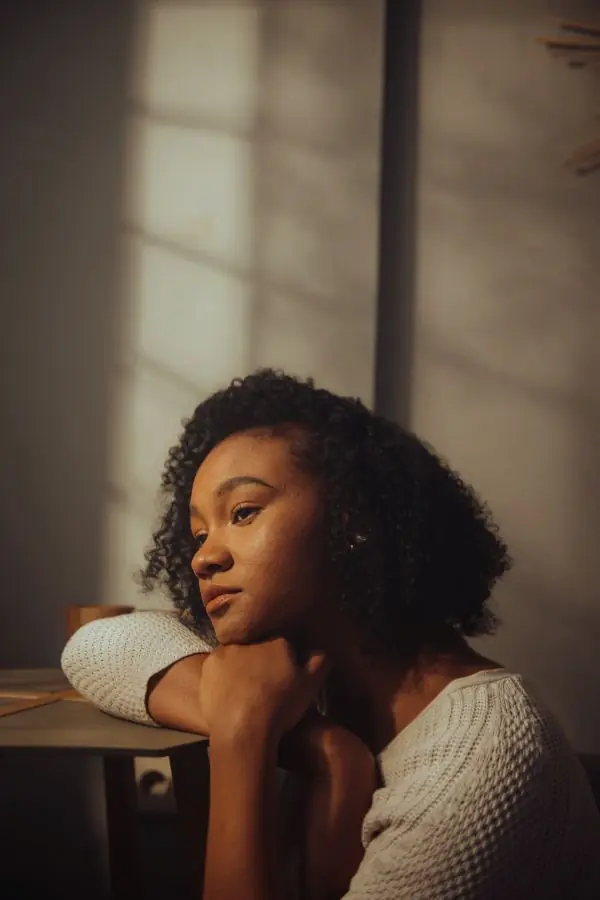 Person mournfully leaning on a table